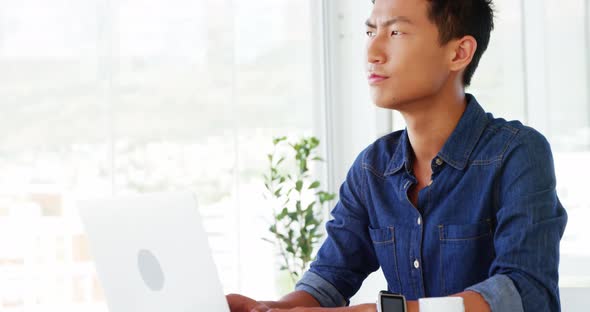 Man thinking using laptop