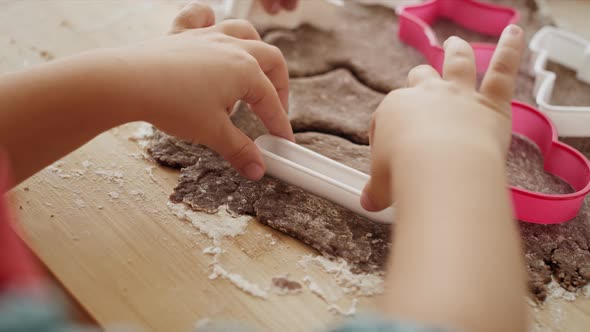 Detail video of children cutting out gingerbread cookies. Shot with RED helium camera in 8K.