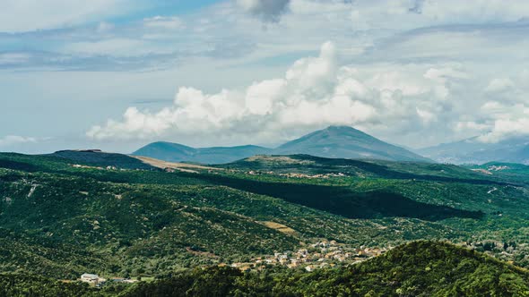 Timelapse Green Mountains and Thick Clouds of Little Houses in the Mountains