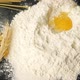 Egg Falling on a Bunch of Flour for making a Dough for Homemade Pasta - VideoHive Item for Sale