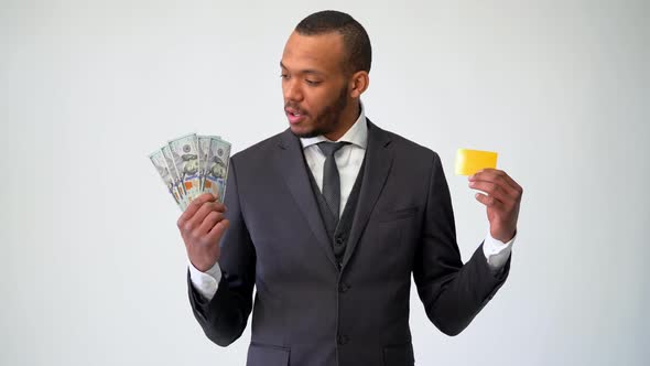African-american Businessman Making Choice Between Credit Card and Money