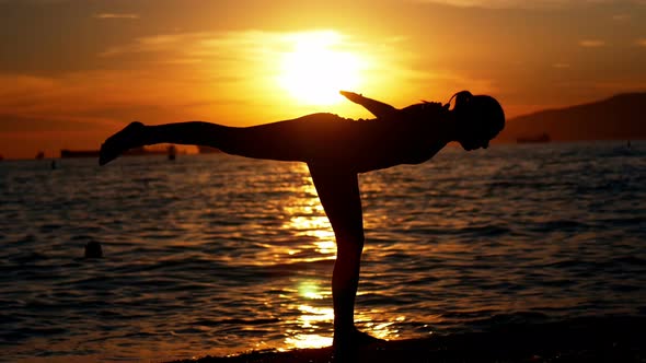 Woman performing yoga on the beach