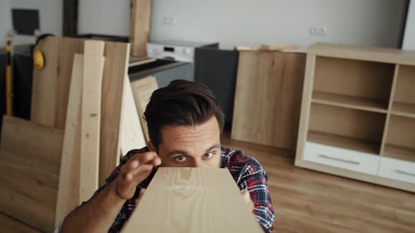  Video of carpenter looking carefully at the piece of plank. Shot with RED helium camera in 8K