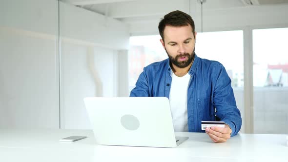 Happy Man Celebrating Successful Online Shopping Credit Card Payment