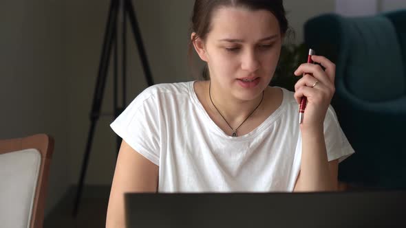 Authentic Caucasian Young Woman Chatting On Laptop At Home In Living Room