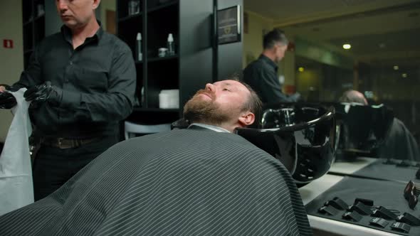 The Barbershop Client Rests Before the Master Begins to Cut