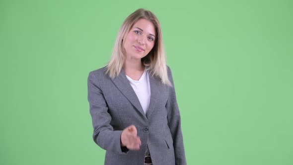 Happy Young Beautiful Blonde Businesswoman Giving Handshake