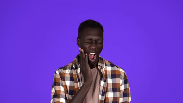 Portrait of Sick African American Man in Plaid Shirt Touching Jawbone with Pain on Face and