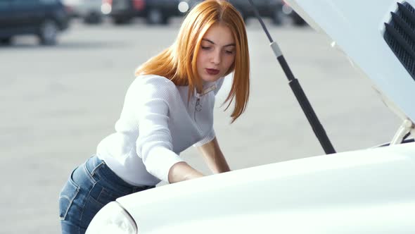 Young Stressed Woman Driver Near Broken Car with Popped Hood Having a Prbreakdown Problem with Her