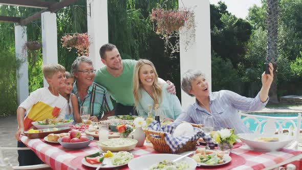 Happy family eating together at table