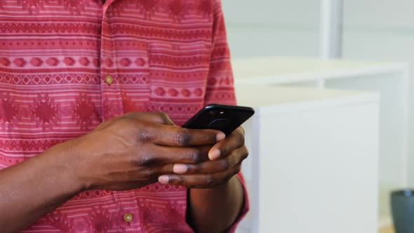 Mid section of male male graphic designer using mobile phone in the office 4k