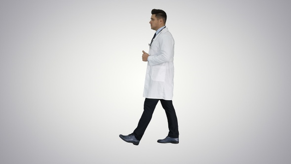 Walking male doctor passing by on gradient background