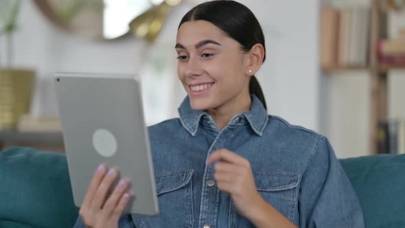 Video Chat on Tablet By Latin Woman