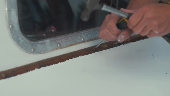 Carpenter ring repairing trim on wooden boat windshield