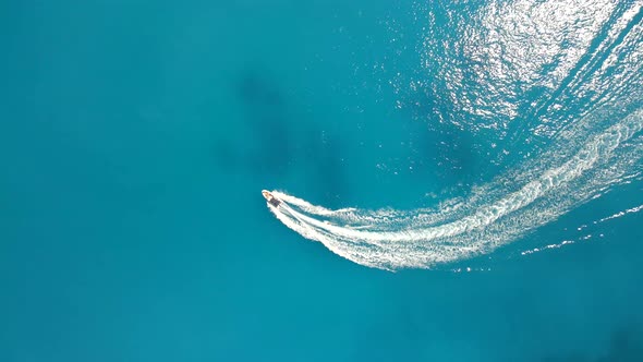 Overhead View of Boat in Blue Sea Water Wakesurfing