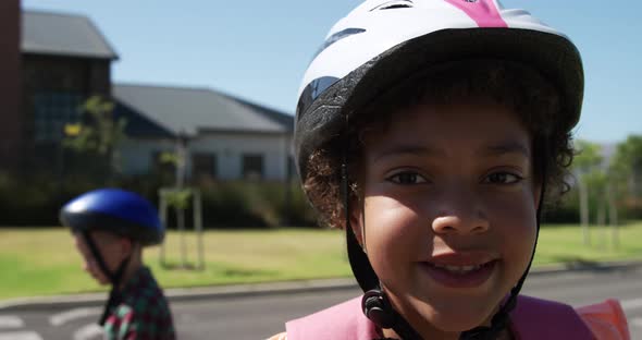 Girl wearing helmet smiling on the road alt
