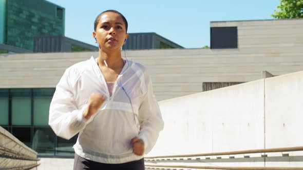 African American Woman with Earphones Running