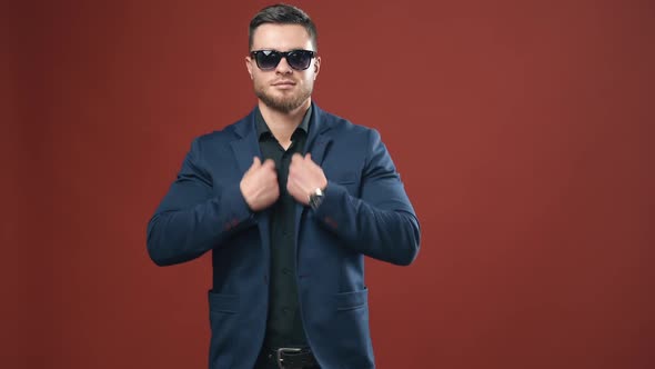 Man posing on studio background. Portrait of handsome man in glasses