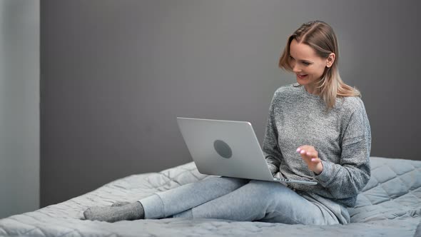 Joyful Feminine Talking Online Video Call Use Laptop on Bed