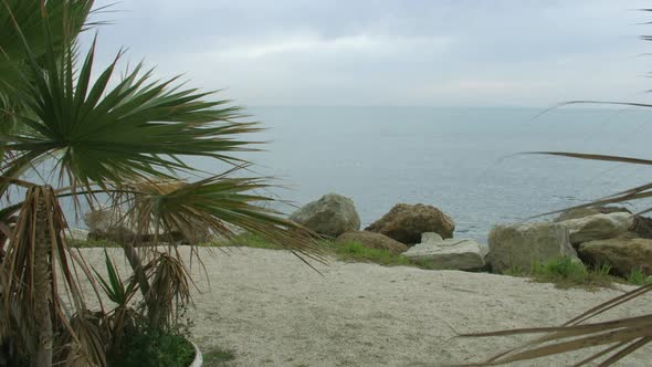 Recreation on Beautiful Sandy Beach With Stones and Palms. Meditation at Seaside