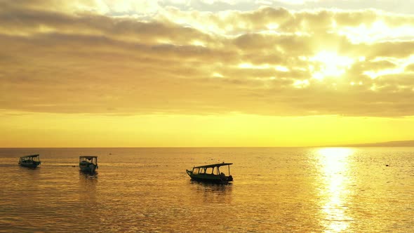 majestic sunray through the dramatic clouds. tropical sandy beach,island and boats. luxury vacation