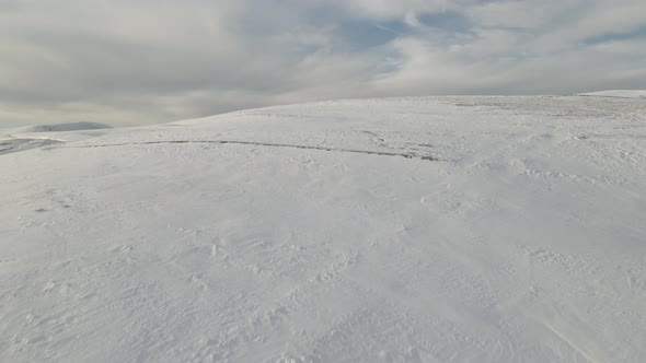 Snowy mountain landscape, aerial view of mountains at sunset near Didgori. Nichbisi. Georgia 2021