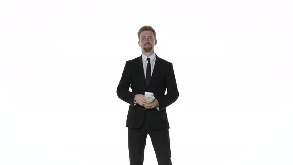 Businessman Throws Money on a White Background