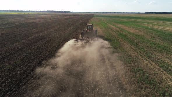 Agricultural Red Big Tractor in the Field Plowing