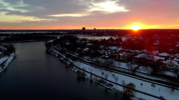 beautiful sun set over lake of the isles during winter time in minneapolis, msp minnesota