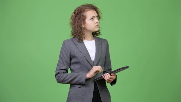 Young Happy Beautiful Businesswoman Thinking While Using Digital Tablet