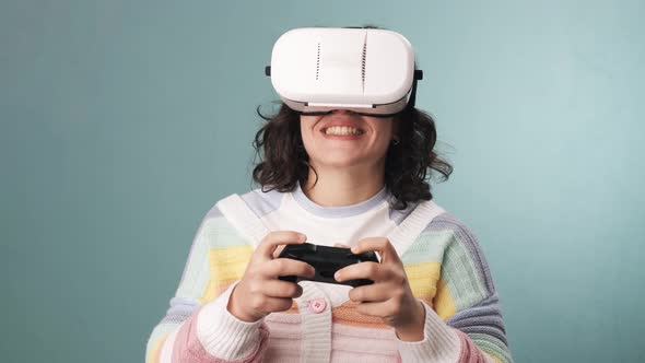 Slow motion video of a woman having fun while playing video games with VR glasses