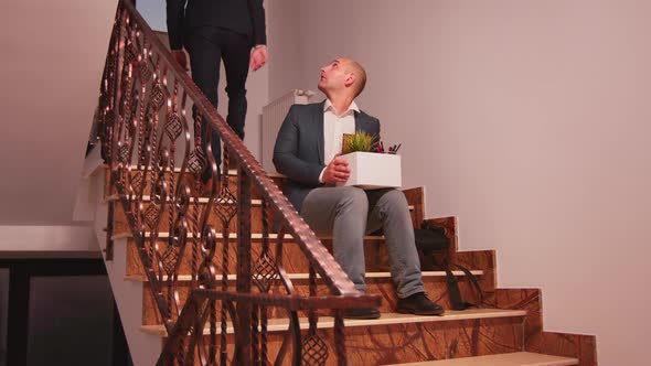 Fired Businessman Sitting on Stairs