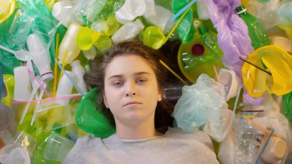 Girl Lying In Pile Of Plastic