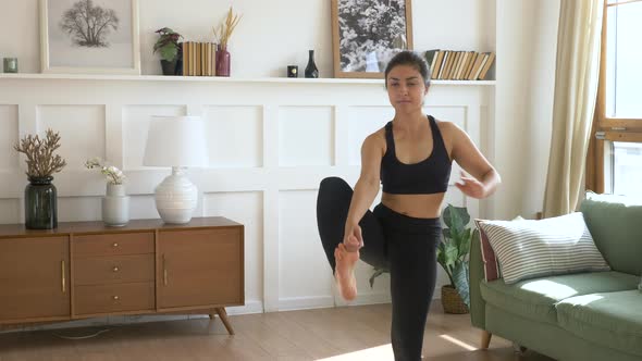 A young Indian Woman Meditates in the Morning, She Does exercises for Balance And Stretching 