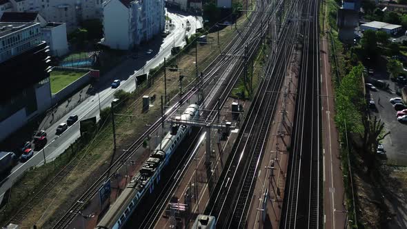 City Passenger Train is Moving on the Track Near the City