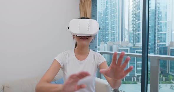 Woman watch on VR device at home