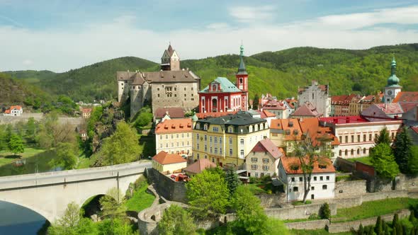 Flight Over Loket Castle Surrounded By River Ohri and Small Houses on a River Shore Near Kariovy