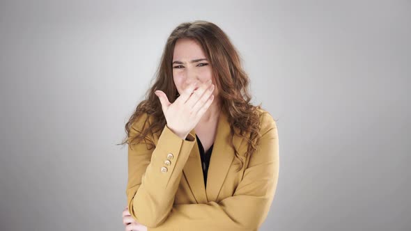 Young Woman is Shocked By Something Unpleasant and Does Not Want to Watch Hiding Her Face