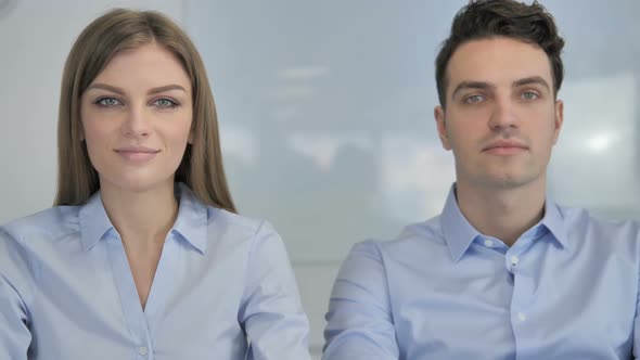 Young Business People Looking at Camera in Office Colleagues