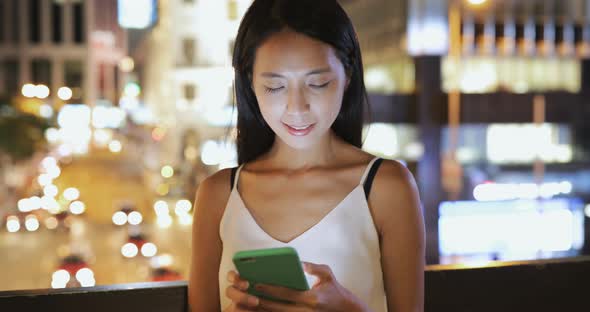 Woman use of smart phone at night 