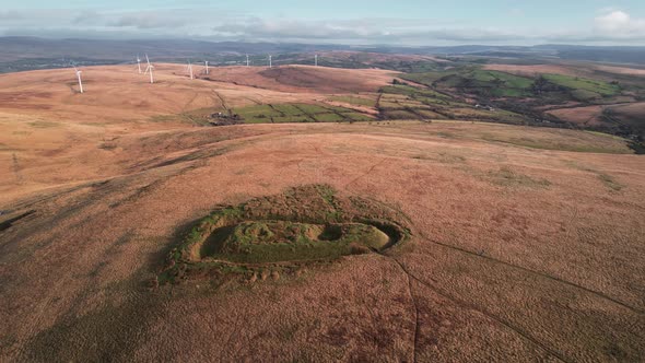 AERIAL: Close circle of historic castle ruins with autumn colours, Penlle'r Castell, 4k Drone