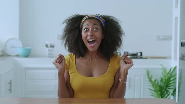 Cheerful Multiethnic Young Woman Dressed in Bright Yellow Wear Looks at Camera with Surprise