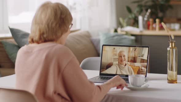 Elderly Woman Chatting with Female Friend on Video Call