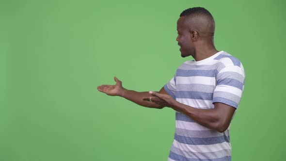 Young Happy African Man Showing Something