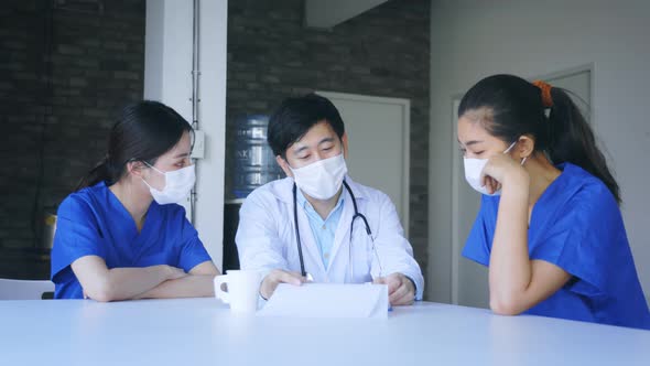 Group of Doctors Discussing Case in Canteen