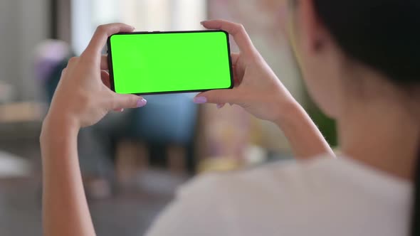 Rear View of Latin Woman Watching Green Screen of Smartphone Chroma Screen