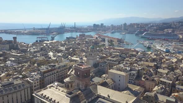 Aerial panoramic drone view of buildings and streets surrounding Port of Genoa.Important hub