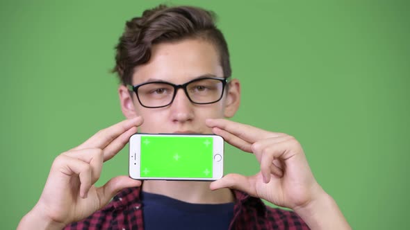 Young Handsome Teenage Nerd Boy Showing Phone