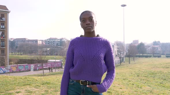 Slow motion shot of young woman standing in park