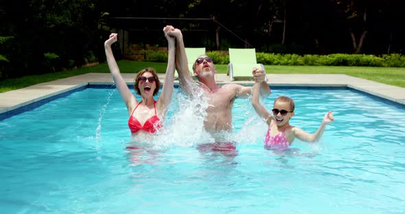 Family enjoying in swimming pool